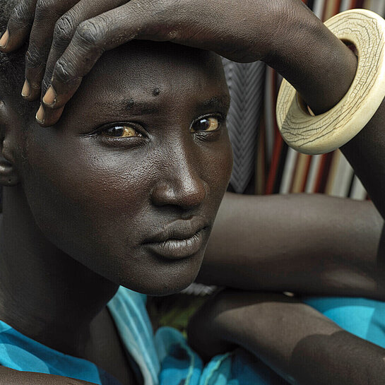 Die junge Frau Nyannyiir aus Südsudan wartet auf die Vergabe von Nahrungsmitteln