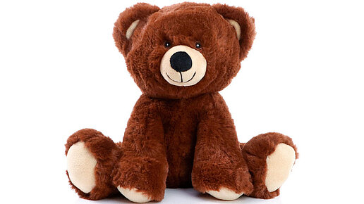 Plüschbär in braun mit hellen Tatzen und Schnauze.