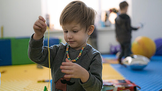 Kleiner Junge spielt im Depaul Day Center in Charkiw