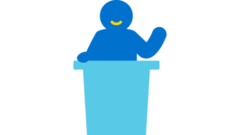 Icon von einer Person, die hinter einem Rednerpult steht und einen Vortrag hält. 