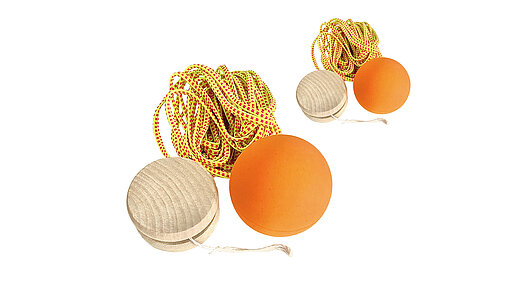 Ein Spiele Set mit Jojo, Flummi und Gummitwist im Vordergrund, ein zweites dahinter.