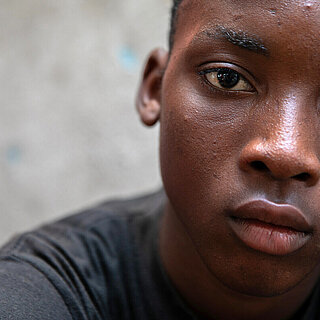 Ein Junge schaut betrübt direkt in die Kamera