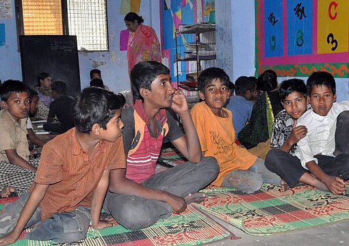 Das „Drop in Centre“ in Dhaka bietet Kindern Schutz Kinder sitzen auf dem Fußboden eines Drop in Centre