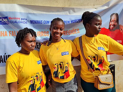 Drei junge Frauen bei einer Veranstaltung für Mädchenförderung