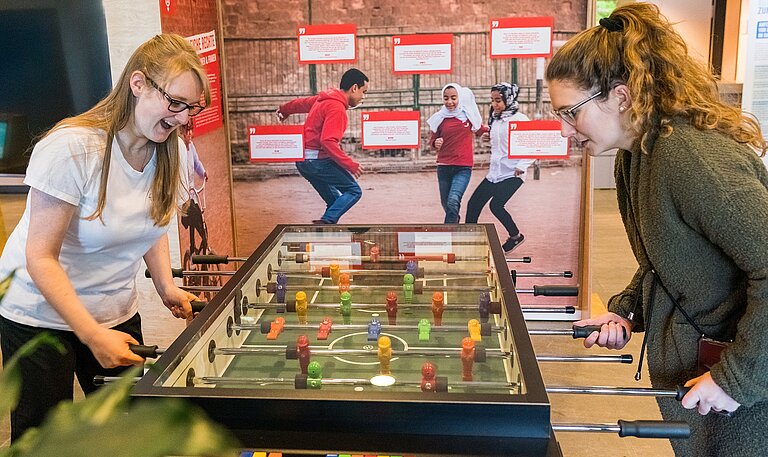 Zwei Frauen spielen Tischkicker