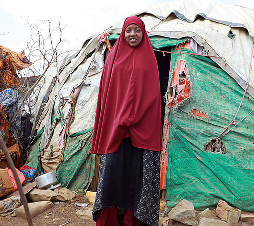 Hibo steht vor ihrem Zelt im IDP Camp in Baidoa