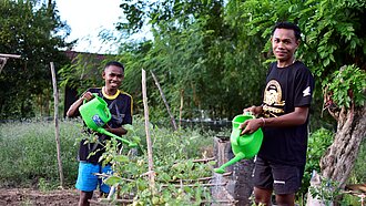 Paul und Taran bewässern Pflanzen 
