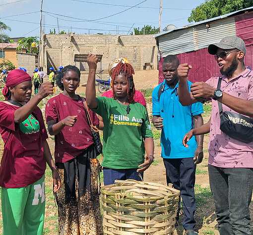 Honorine leitet eine Jugendgruppe beim Pflanzen von Bäumen in ihrer Gemeinde in Togo